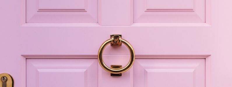 Golden,Door,Knocker,On,A,Pink,Door,Creates,An,Elegant